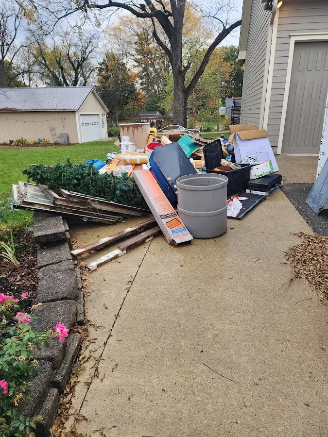 Dumpster being loaded with debris for Estate Cleanout Dumpster Rental in Broken Arrow
